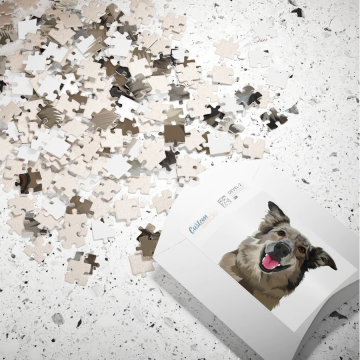 Puzzle pieces scattered with a completed dog portrait on the box.